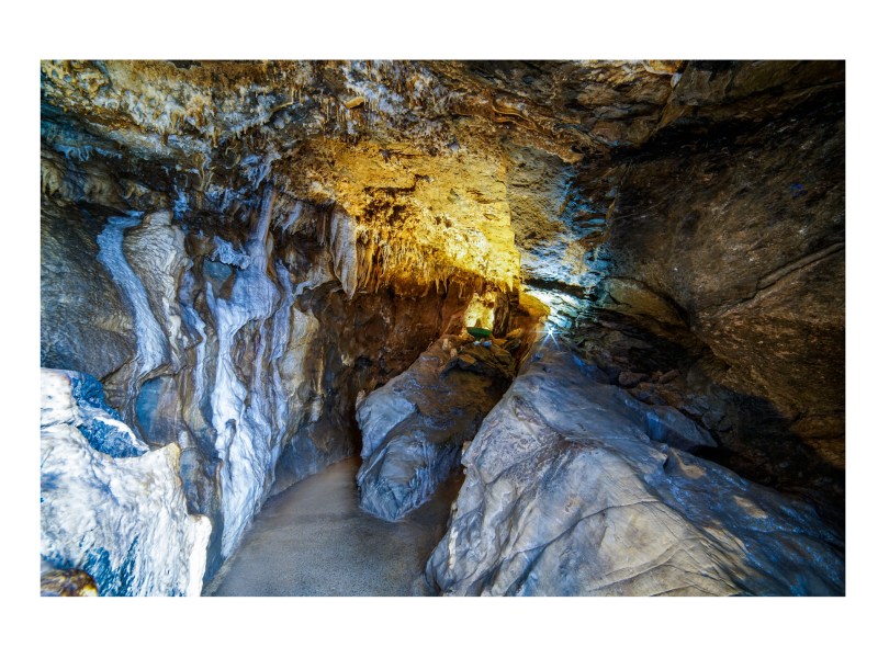a large waterfall next to a rock