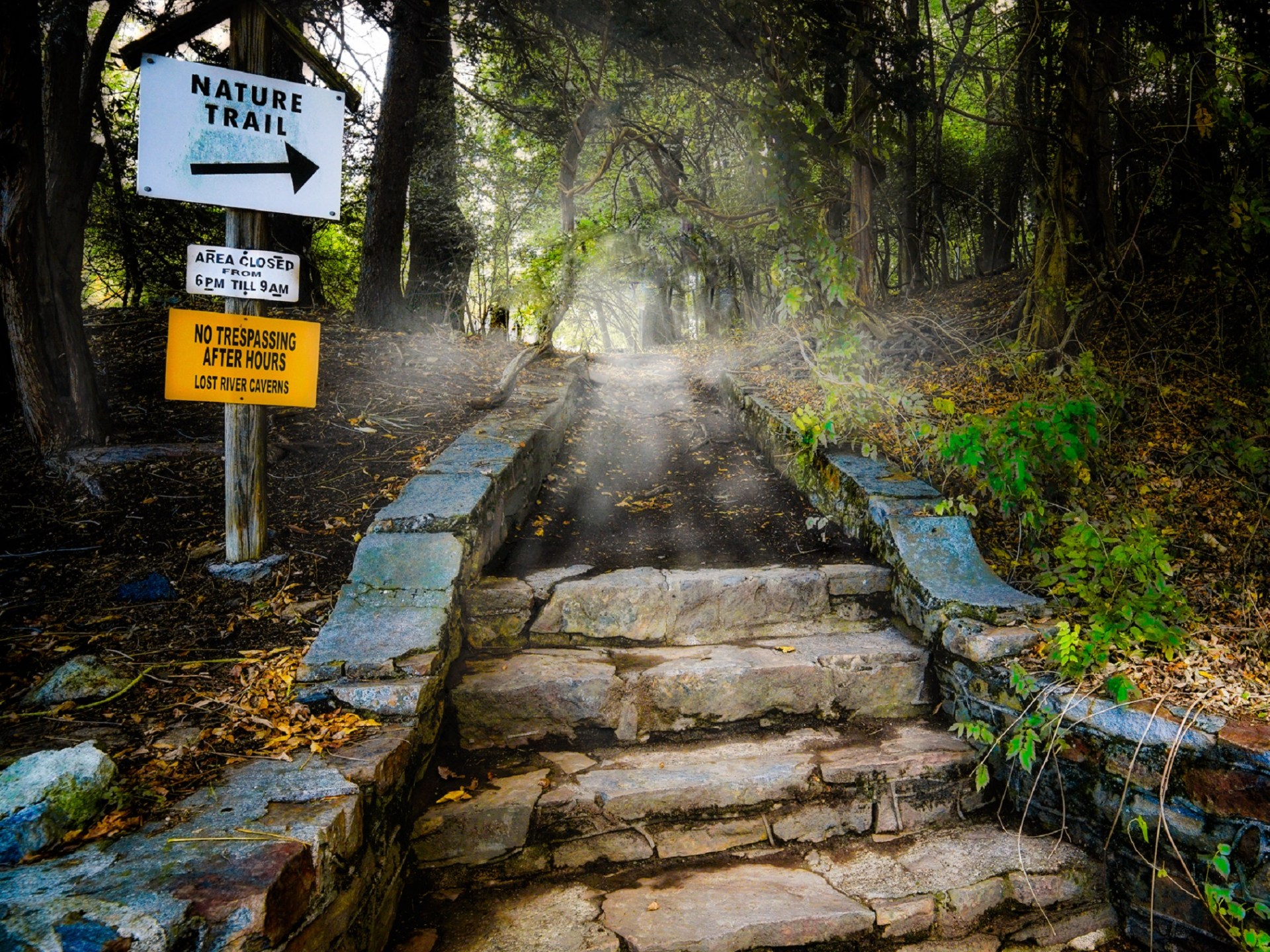 a sign on the side of a waterfall